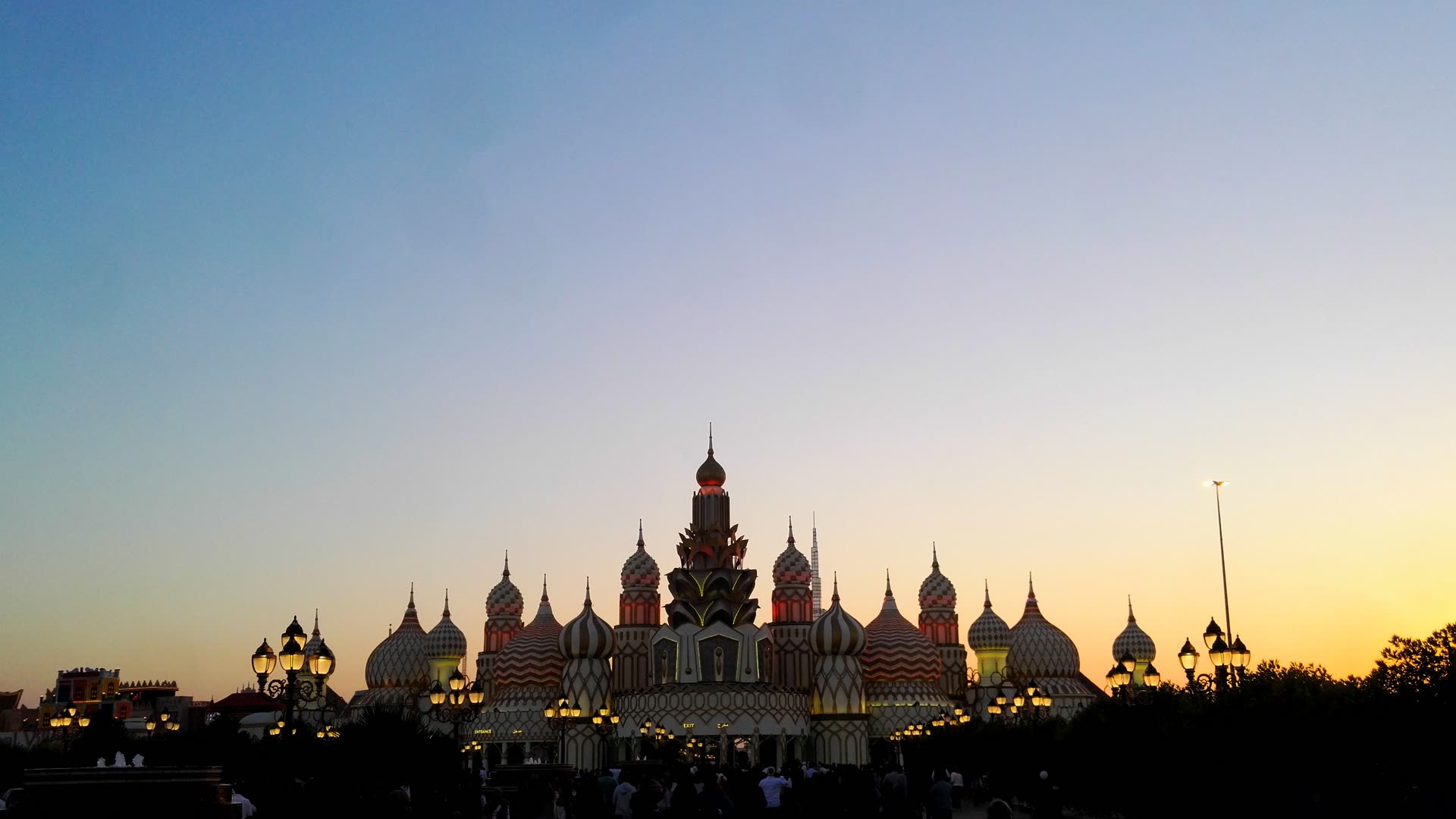 Global Village Dubai entrance arch at dusk